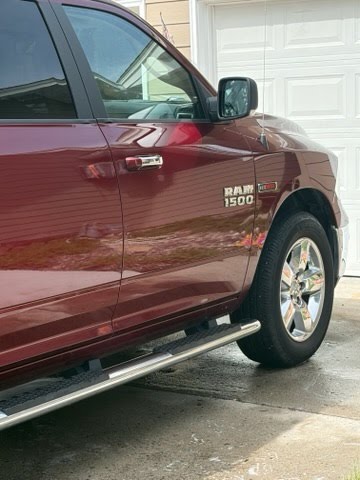 Polished passenger side of red Ram