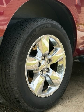 Clean chrome rear wheel on red Ram
