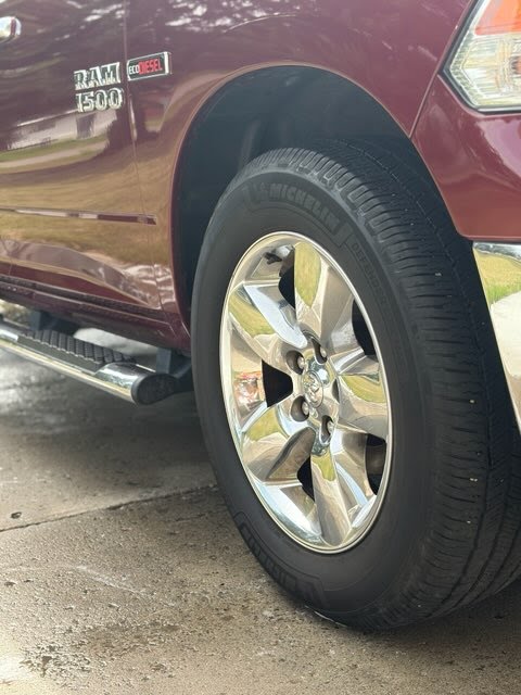Clean chrome front wheel on red Ram